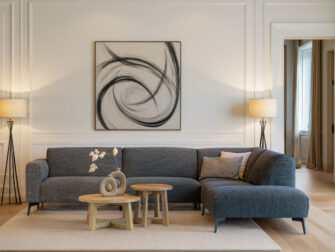 Eigentijdse loungebank met brede armleuningen en slanke zwarte poten