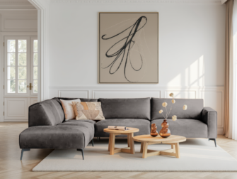 Grijze hoekbank met stevige kussens en minimalistische afwerking