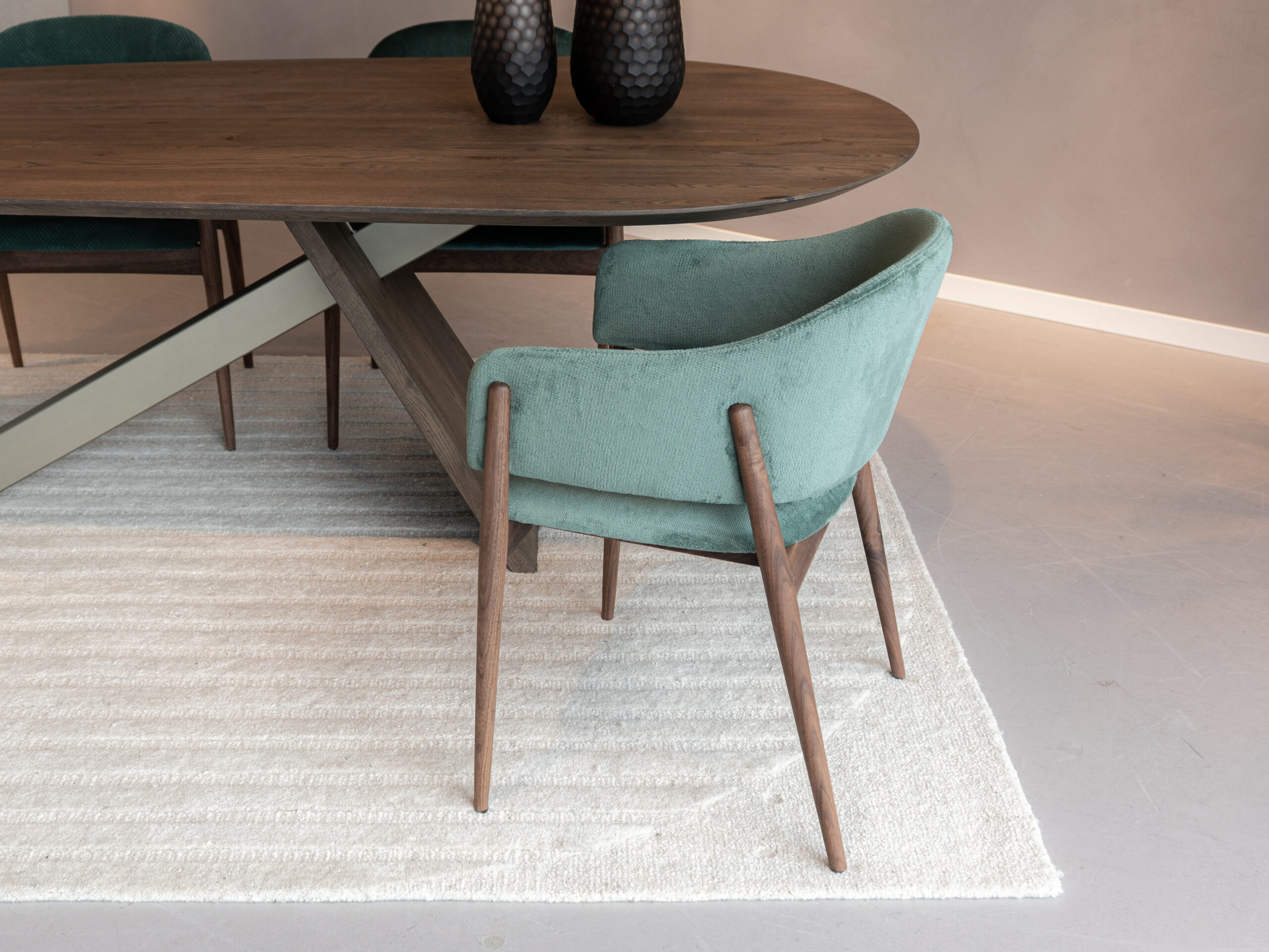 Eetkamerstoel met donkere houten poten in groene stof